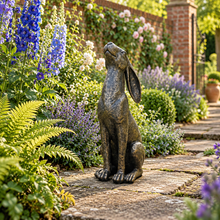Laden Sie das Bild in den Galerie-Viewer, Moon gazing hare garden ornament in aged gold finish, 38 cm tall, in a landscaped garden