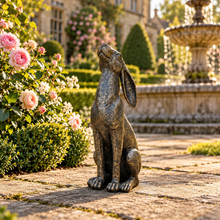 Laden Sie das Bild in den Galerie-Viewer, Moon gazing hare garden ornament in aged gold finish, 38 cm tall, in a landscaped garden