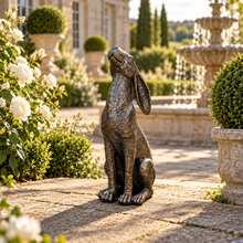 Laden Sie das Bild in den Galerie-Viewer, Moon gazing hare garden ornament in aged gold finish, 38 cm tall, in a landscaped garden