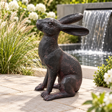 Charger l'image dans la galerie, 36cm bronze effect Alert Hare in Modern garden with pale paving, ornamental grasses, white flowers and a sleek water cascade