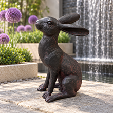 Charger l'image dans la galerie, Alert Hare ornament in a modern courtyard with alliums and wall waterfall