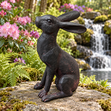 Charger l'image dans la galerie, Alert Hare ornament in a woodland garden with rhododendrons and waterfall