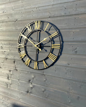 Load image into Gallery viewer, Black Skeleton frame outdooor/Indoor clock with gold hands and gold numerals
