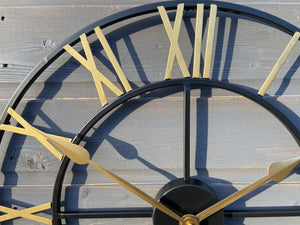 Black Skeleton frame outdooor/Indoor clock with gold hands and gold numerals