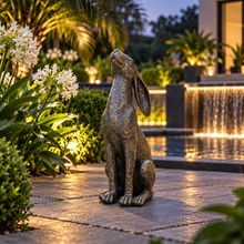 Laden Sie das Bild in den Galerie-Viewer, Moon gazing hare garden ornament in aged gold finish, 38 cm tall, in a landscaped garden
