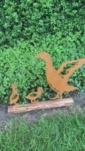 Load and play video in Gallery viewer, Rusty metal duck and two ducklings displayed on a log of wood
