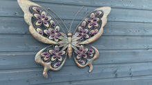 Video laden en afspelen in Gallery-weergave, Handmade Metal Butterfly gold with blue touch Garden Wall Art with purple Decorative Stones measuring 49 x 4 x 70CM
