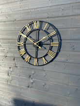 Laden Sie das Bild in den Galerie-Viewer, Black Skeleton frame outdooor/Indoor clock with gold hands and gold numerals
