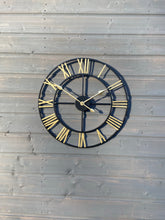 Laden Sie das Bild in den Galerie-Viewer, Black Skeleton frame outdooor/Indoor clock with gold hands and gold numerals
