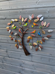Coloured birds in a heart shaped tree wall art for indoors/outdoors