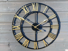 Afbeelding in Gallery-weergave laden, Black Skeleton frame outdooor/Indoor clock with gold hands and gold numerals
