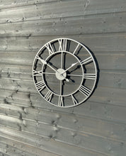 Indlæs billede til gallerivisning Silver framed Skeleton clock with silver numerals and silver hands
