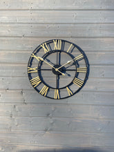 Afbeelding in Gallery-weergave laden, Black Skeleton frame outdooor/Indoor clock with gold hands and gold numerals
